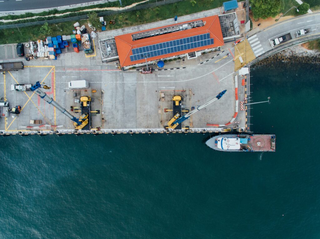 shipping and trade is increasing. 2 cargo ships are being built in a shipyard, with a bird's eye view from above