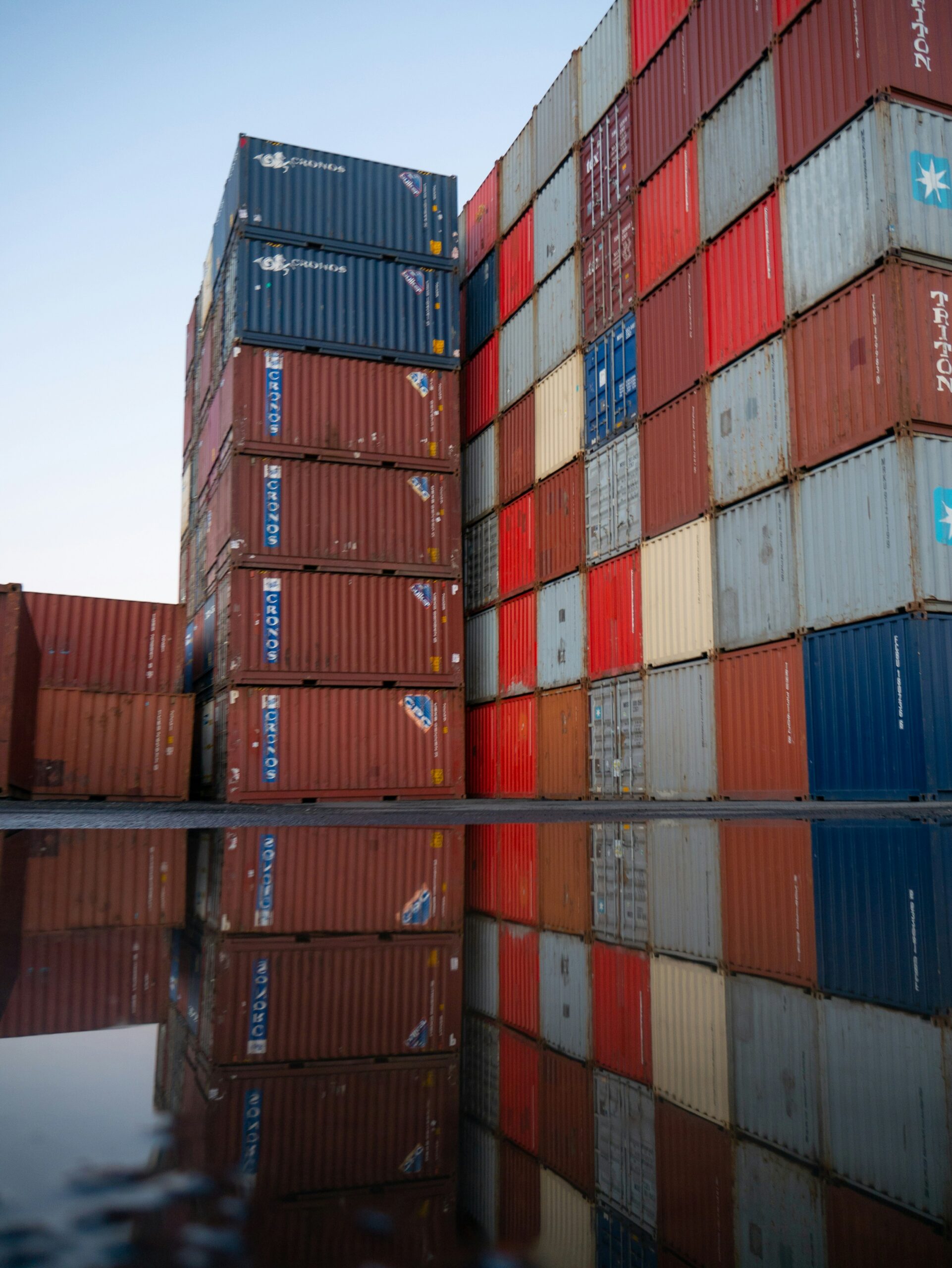 Ocean containers stacked and reflected in the water