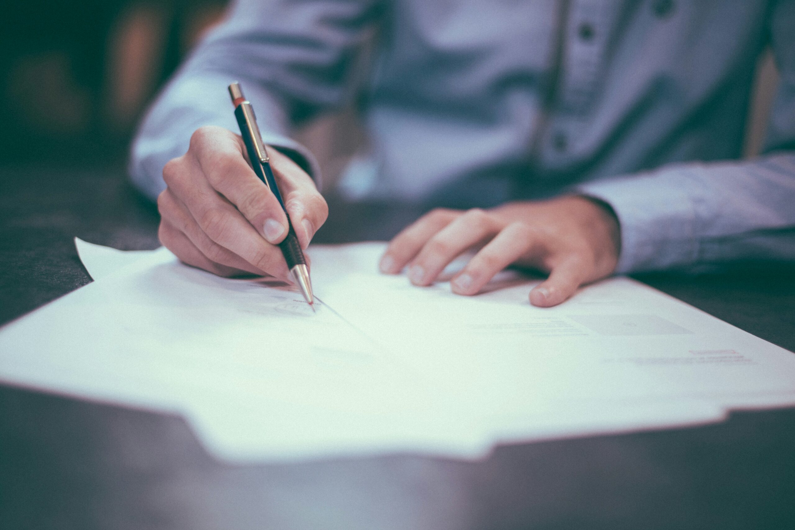 An insurance worker offering a document to sign